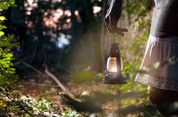 istock Woman with lantern in dark forest 471891777