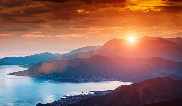 Sun beams through clouds Summer sunset at Kotor's bay. montenegro stock pictures, royalty-free photos & images