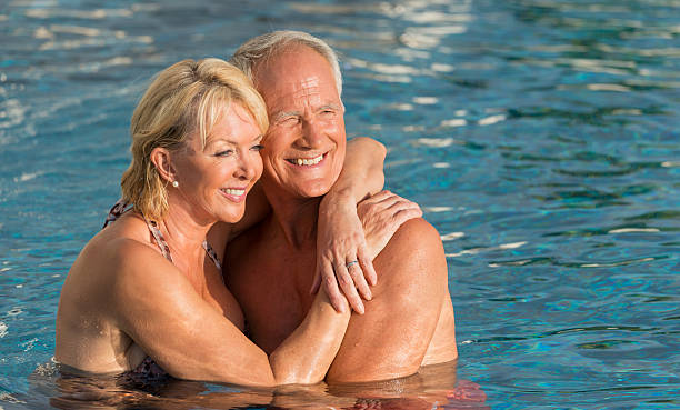 istock Senior Couple In The Swimming Pool 471892429