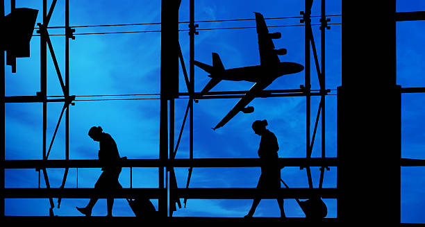 istock People silhouettes at airport building 471892911