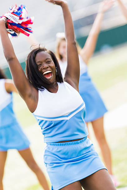 istock Excited cheerleader cheering for football team from sidelines 471893459