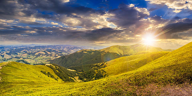 istock summer green meadow in mountain panorama at sunset 471894206