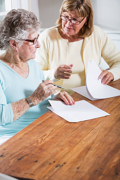 istock Elderly woman reading paperwork 471894417