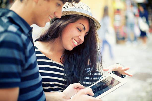 istock Young couple is looking pictures on digital tablet 471895027