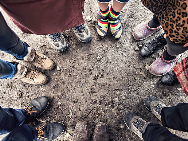 istock feet of people standing in a circle 471897036