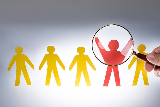 istock Hand Magnifying Red Paperman Representing Recruitment 471897156