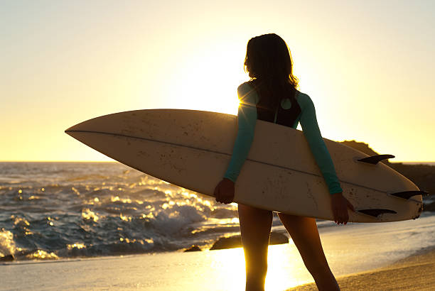 Surfer girl silhouette stock photo