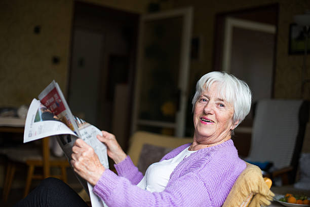 istock Senior woman reading morning newspaper 471897760