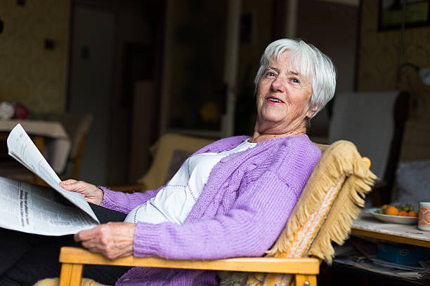 istock Senior woman reading morning newspaper 471897822