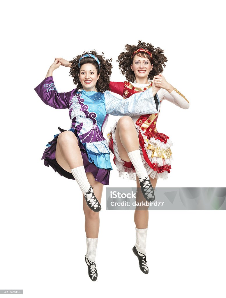 Two young women in irish dance dress dancing isolated Two young women in irish dance dress and wig dancing isolated Dancing Stock Photo