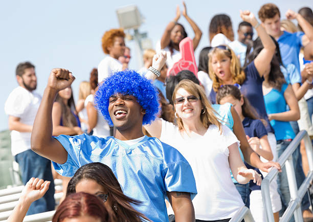 istock Happy sports fans celebrating win as they exit stadium 471898269