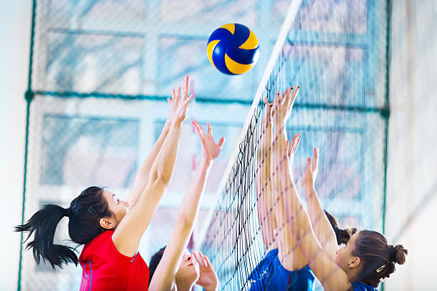 High school female volleyball team in action.