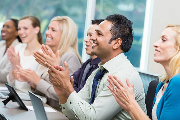 istock Diverse group of business executives applauding during conference 471898513