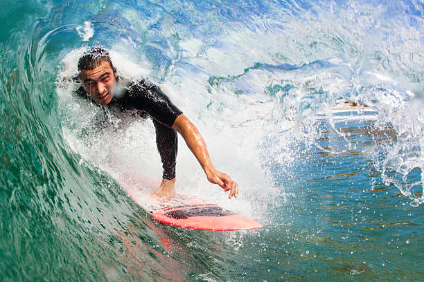 surfing surfer in the barrel of a wave man wearing a barrel stock pictures, royalty-free photos & images