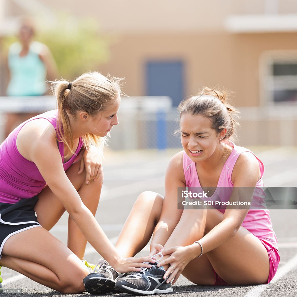 High school athlete crying after being injured during track meet Physical Injury Stock Photo