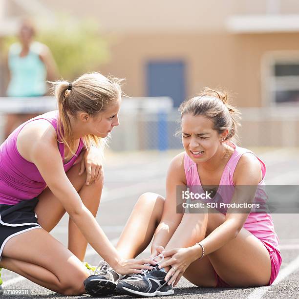 High School Athlete Crying After Being Injured During Track Meet Stock Photo - Download Image Now