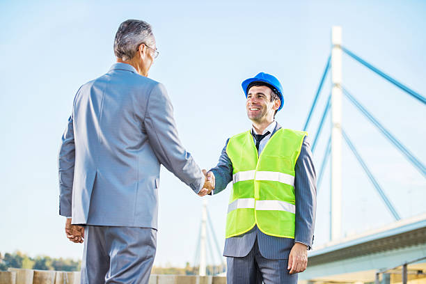 istock Businessman and architect shaking hands outdoors. 471899561