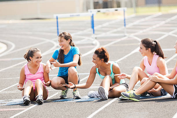 istock High school athletes sitting on track after jumping hurdles 471899927