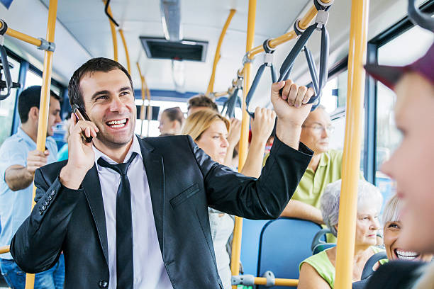 istock Mid adult man talking on phone while commuting by bus. 471902243