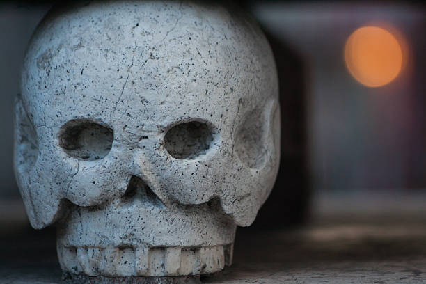 istock Human scull made of stone 471902458