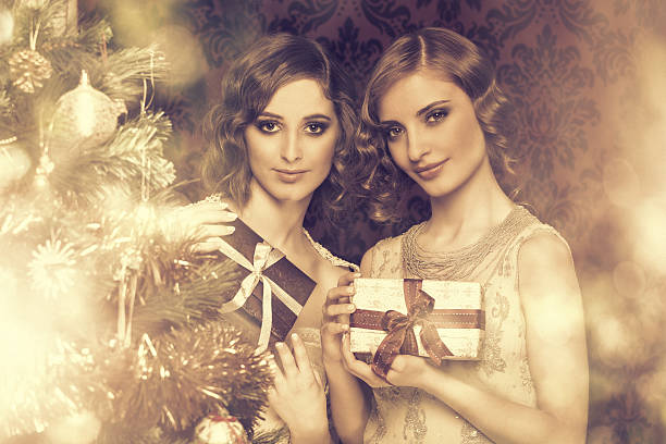 istock retro christmas - grils holding wrapped presents 471905761