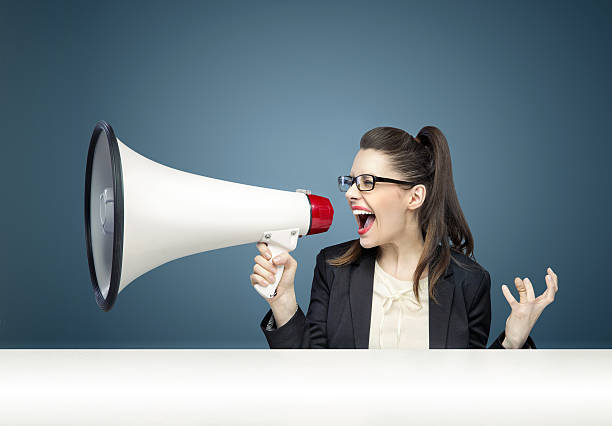 istock Businesswoman angrily yelling through a megaphone 471905952