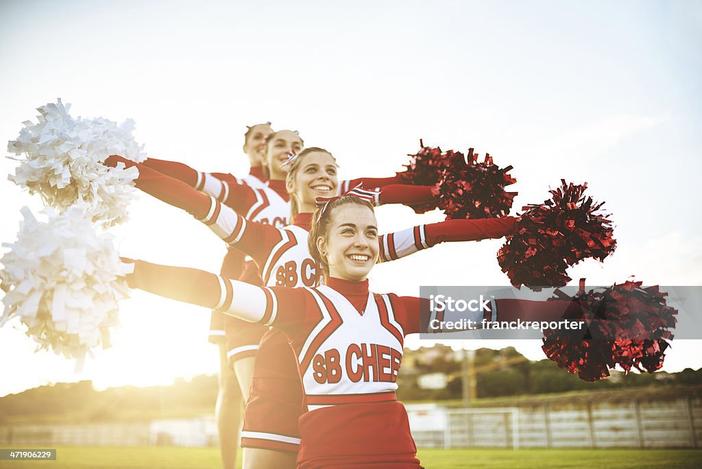 Felicità cheerleaders in posa con pon-pon - Foto stock royalty-free di Ragazza pon pon