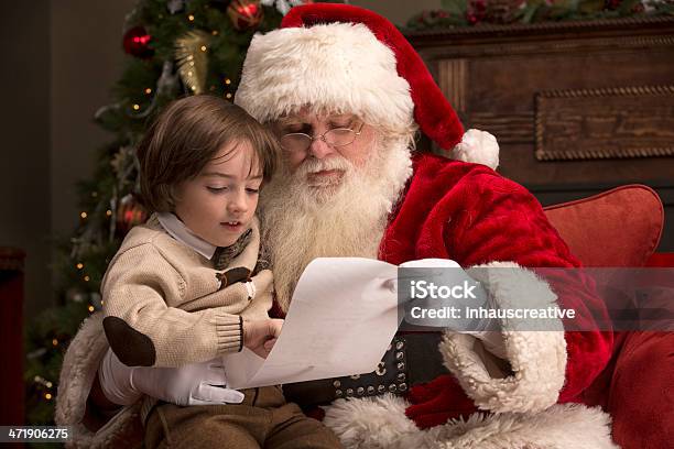 Boy Going Over Naughty Nice List With Santa Stock Photo - Download Image Now - Santa Claus, Child, Boys