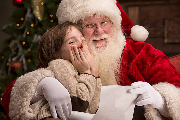 istock Boy going over naughty nice list with Santa 471906277