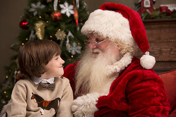 istock Boy looking at Real Santa Claus 471906289