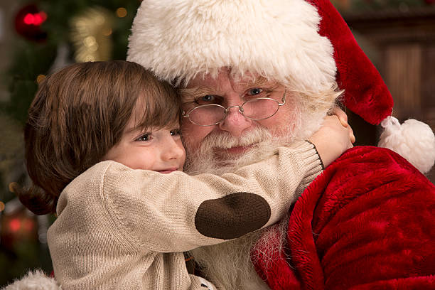 istock Boy Hugging Real Santa Claus 471906299