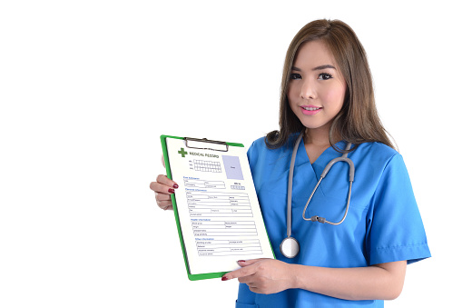 Female doctor with medical record form on clipboard in hands on white background.