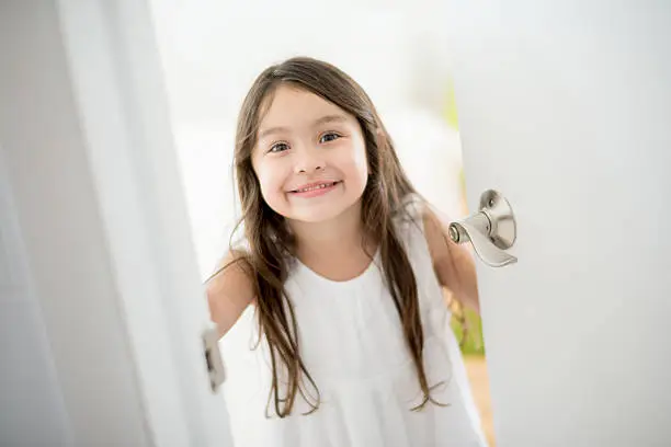 Photo of Girl opening the door of her room