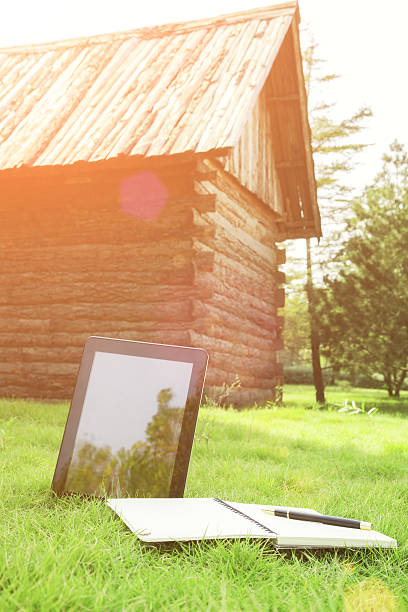 istock Leisure:digital tablet in forest with the wood house 471906685