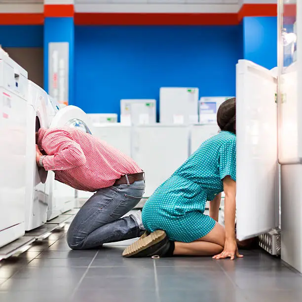 Photo of Young Couple Checking Whiteware in Appliance Store