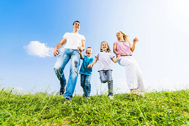 istock Family running in a meadow. 471907861