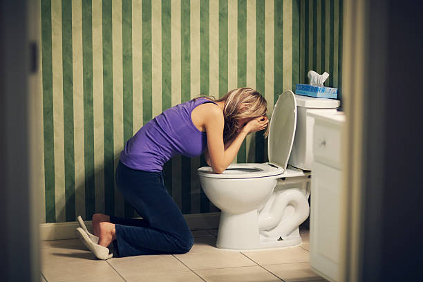 Sick woman with nausea at toilet stock photo