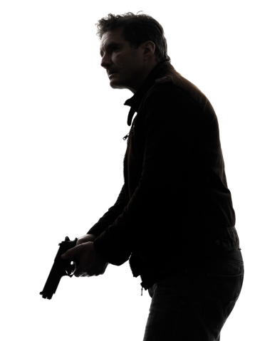 one man killer policeman holding gun silhouette studio white background