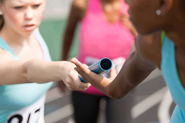 istock Sports:  Women's relay race, track competition. Passing baton. 471909139
