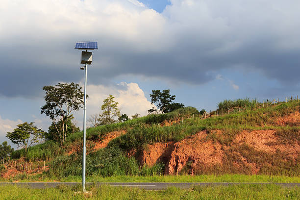 Solar panel on electric pole on road  for lightning Solar panel on electric pole on road  for lightning in countryside, use of Solar energy, Rio de Janeiro, Brazil concentrated solar power photos stock pictures, royalty-free photos & images