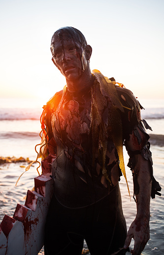 zombie surfer shuffling out of the water