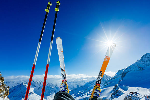 heap of skis near ski slope