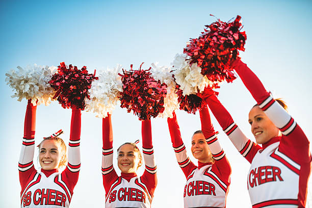 istock Happiness cheerleaders posing with pon-pon and arm raised 471910099