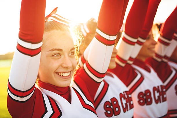 istock Happiness cheerleaders posing with pon-pon and arm raised 471910149