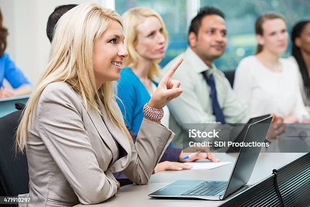 Young Woman Asking Question During Conference Lecture Or Seminar Stock Photo - Download Image Now