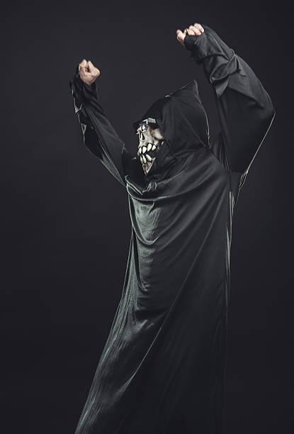 istock skeleton in a black robe with glasses dancing 471911229
