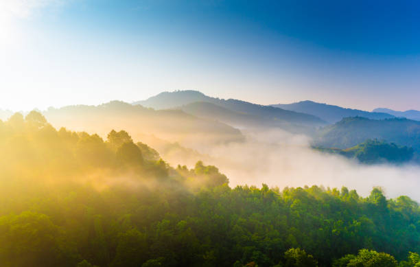 Beautiful sunshine at misty morning mountains . stock photo