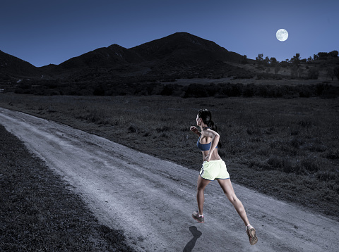 A women running on a mountain road at night with a full moon. http://blog.michaelsvoboda.com/AizhanBanner.jpg
