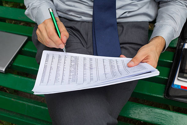 istock Hands of businessman with  notes and pen. 471911359