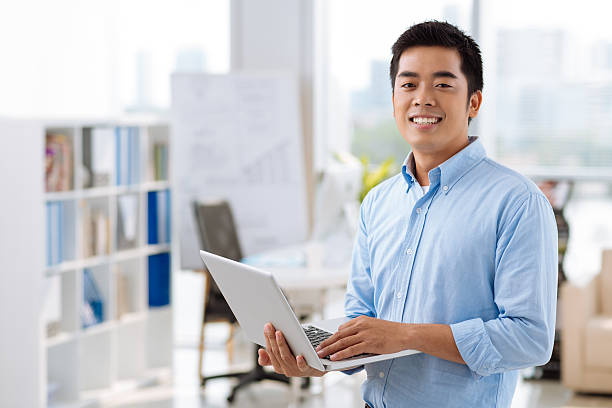 istock Vietnamese manager with laptop 471911670